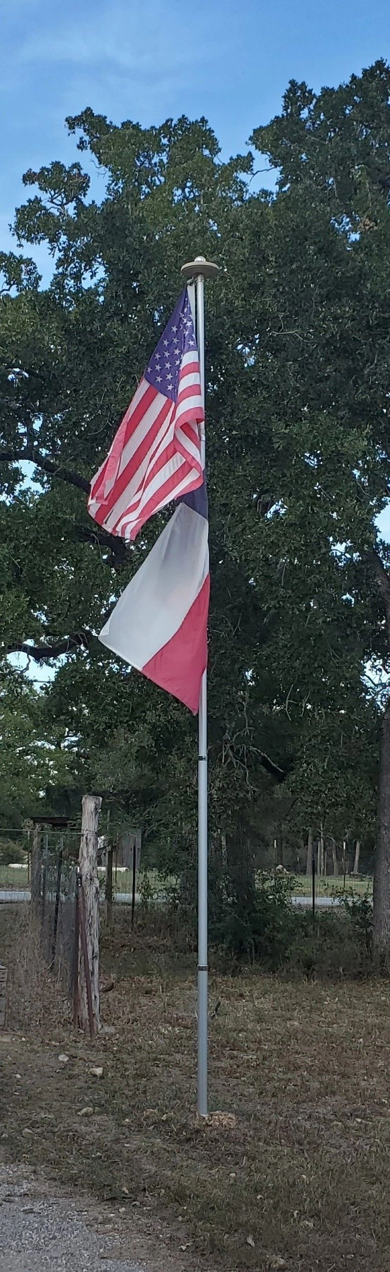 American and Texas flags on a flagpole in Cedar Creek