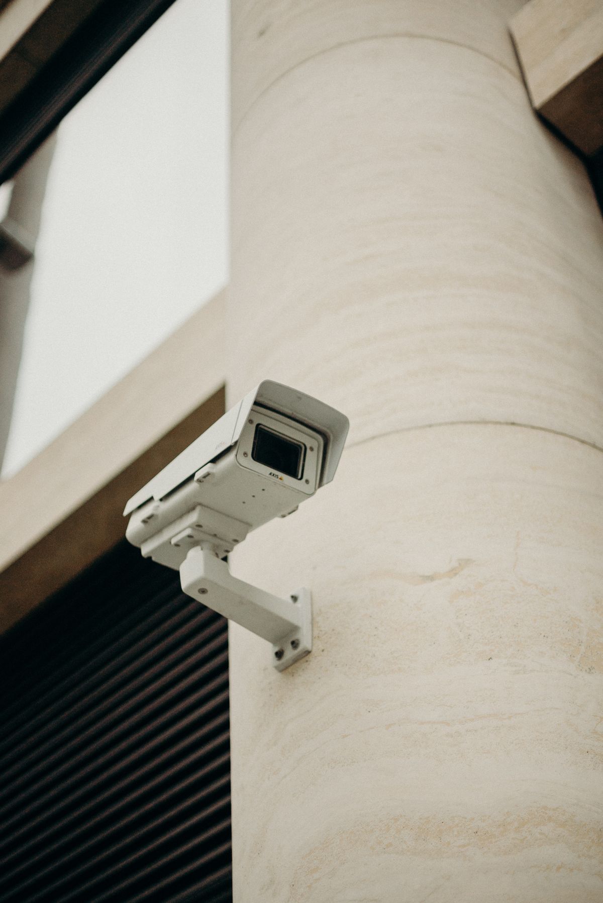 White security camera mounted on a concrete building column